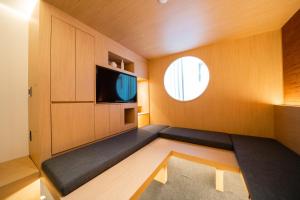 una pequeña sala de estar con TV y ventana en Y Collection by Unboundi Gyeongju en Gyeongju