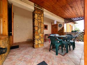 a patio with a table and chairs on a patio at WatAir House Apartman Sarud in Sarud