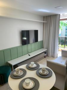 uma sala de estar com duas mesas com copos em Flat no Life Resort a Beira Lago em Brasília