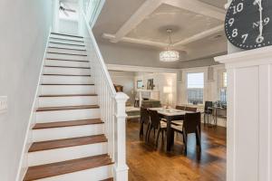 a staircase leading to a dining room and kitchen with a clock at Family Laundry & Spa in Sacramento