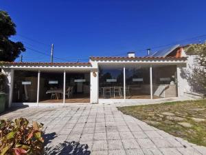 a house with sliding glass doors and a patio at Monteferro, Nigrán, chalet con finca in Nigrán