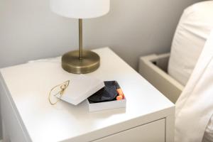 a bedside table with a lamp and a box on it at Family Laundry & Spa in Sacramento