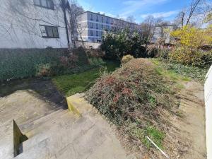 a yard with a pile of weeds next to a building at Fantastic Mokotow - FMG Pokoj P in Warsaw