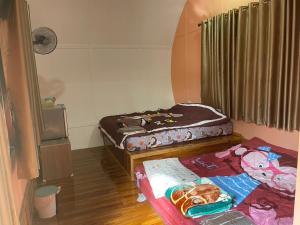 a room with two beds sitting on the floor at ANGEL RESORT i in Amphoe Sawang Daen Din