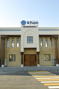 a brick building with a sign on top of it at Khan Hotel Samarkand in Samarkand