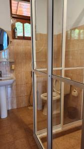 a small bathroom with a toilet and a sink at SunnySide Lodge - Tea Plantation Bungalow in Ella