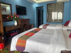 Postel nebo postele na pokoji v ubytování Sapa Hills Hotel