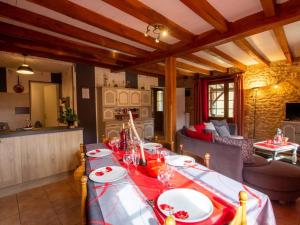 a dining room with a table and a living room at Maison familiale près de Limeuil avec jardin, jeux pour enfants, WiFi et animaux acceptés - FR-1-616-84 in Limeuil +16 photos
