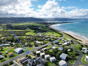 an aerial view of a beach with houses and the ocean at Beachfront Holiday Home in Apollo Bay