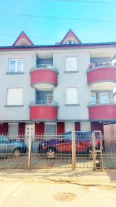 a building with cars parked in front of it at The Sunshine apartment in Prilep