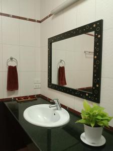 a bathroom with a sink and a mirror at Doodle Lodge Bangkok in Bangkok