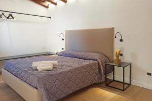 a bedroom with a bed with two towels on it at Residence Cortile Mercè in Trapani