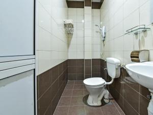 a bathroom with a toilet and a sink at Capital O 90761 D Jiwa Hotel in Pendang