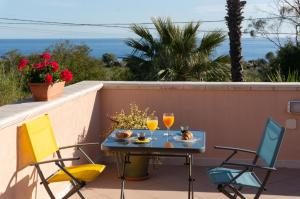 a patio with a table and two glasses of wine at B&B Villa Nella in Augusta