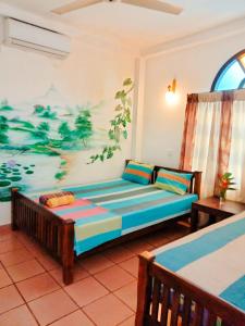 a living room with a couch and a painting on the wall at Backpacker Galle Hostel in Galle