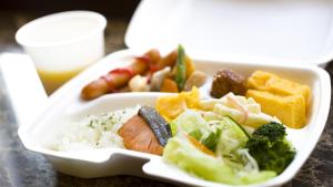 a white tray of food with rice and vegetables at Toyoko Inn Hokkaido Okhotsk Abashiri Ekimae in Abashiri
