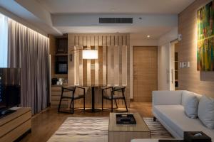 a living room with a couch and a table at Brittany Hotel BGC in Manila