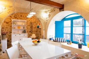 - une cuisine avec une table blanche et des chaises blanches dans l'établissement Authentic Country Home with Incredible Outdoor Area, à Ix-Xagħra