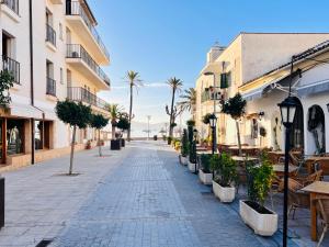 an empty street with palm trees and buildings at Tuent in Port de Pollensa