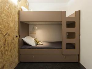 a bunk bed with a toy monkey sitting on it at Studio Les Arcs 2000, 1 pièce, 5 personnes - FR-1-346-365 in Arc 2000