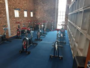 a row of bikes parked in a gym at Barons Galley & Lodge in Hartswater