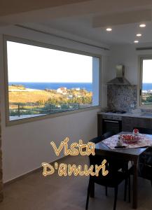 a large window in a kitchen with a dining room table at VISTA D'AMURI in Sciacca
