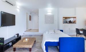 a bedroom with a bed and a table and a tv at LongLands Peak at Windmill Hill in Albufeira