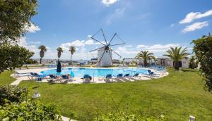 a windmill next to a swimming pool with a windmill at LongLands Peak at Windmill Hill in Albufeira