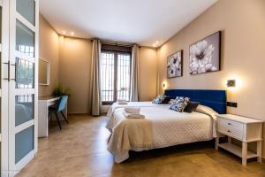 a bedroom with a king sized bed and a desk at Villa Burguillos in Burguillos +63 photos