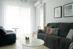 a living room with a couch and a table at ALEX APARTMENT in Strovolos