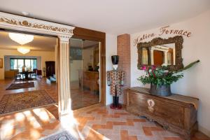 a living room with a mirror on the wall at Antica Fornace Relais by La Principina in Principina Terra