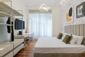 a bedroom with a large bed and a desk with a computer at Your 4 bdrm Dream House Acropolis View & Jacuzzi in Athens