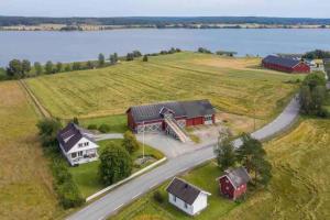 an aerial view of a house and a road next to a lake at Veslestua - Beach Bliss & Fishing Fun in Hemnes