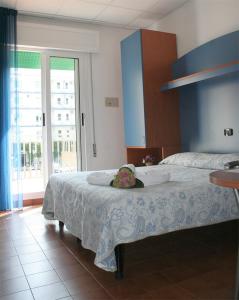 a bedroom with a bed with a flower on it at Hotel Trifoglio in Lido di Jesolo