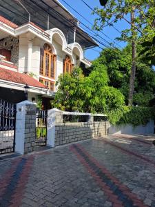 a house with a gate and a brick driveway at The Nook Home in Ernakulam
