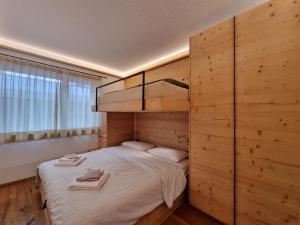 a bedroom with a bunk bed with two towels on it at Riverside 1st Floor South in Saas-Fee