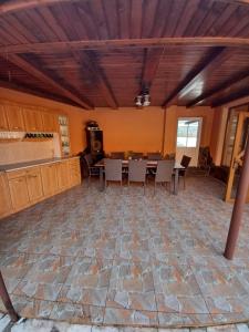 a kitchen and dining room with a table and chairs at Pensiune lângă Mănăstirea Izbuc in Călugări