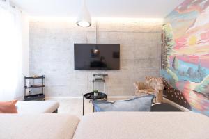 A television and/or entertainment centre at Moyua Luxe by Staynnapartments