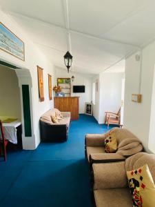 a living room with two couches and a couch at Zion White House in Nuwara Eliya