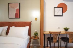 a bedroom with a bed and a table at Bruno 55 By Peraia in Tel Aviv