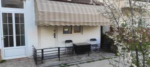 a porch of a house with a table and chairs at Apartment Sekulovski in Ohrid