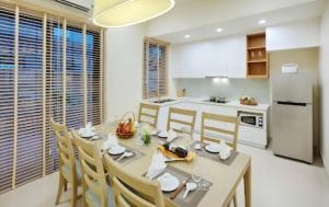 a kitchen and dining room with a table and chairs at Royal Lotus Hạ Long Resort & Villas in Ha Long