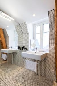 ein Badezimmer mit zwei Waschbecken und einem großen Spiegel in der Unterkunft Le Grand Amerval in Nancy