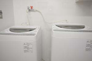 two toilets sitting next to each other in a room at ゲストハウス昴 in Tokyo