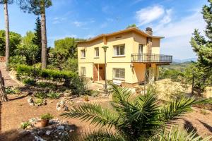 a house on top of a hill with trees at Catalunya Casas Elegant Mountain Villa just 30km to Barcelona in Corbera de Llobregat