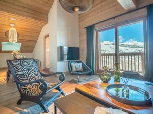 a living room with a zebra chair and a table at Appartement Valmorel, 5 pièces, 8 personnes - FR-1-356-417 in Valmorel