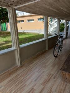 a bike parked in a room with windows at Tskaltubo Guest House On Mirian Mepe in Tskaltubo