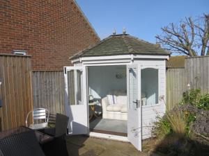 a white gazebo with an open door at Hunnydorm in Hunstanton