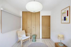 a living room with a chair and a table at Pirane House 201 東京スカイツリー浅草 押上駅が徒歩圏内 無料wifi in Tokyo