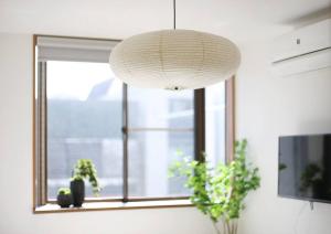 a white lamp hanging in front of a window at Pirane House 201 東京スカイツリー浅草 押上駅が徒歩圏内 無料wifi in Tokyo